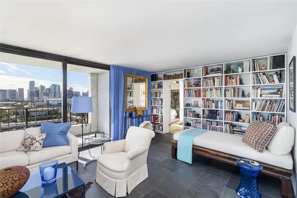 a living room with furniture and a floor to ceiling window