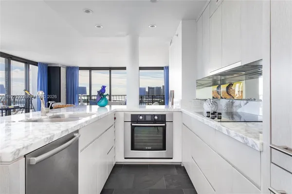 a kitchen with a sink stove and cabinets