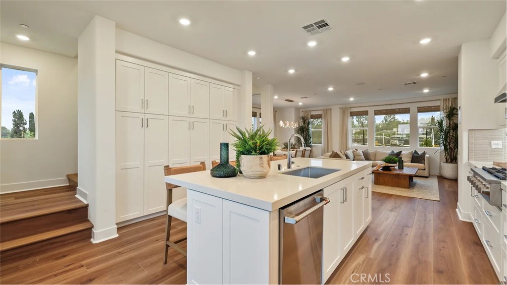 a kitchen with sink stove and refrigerator
