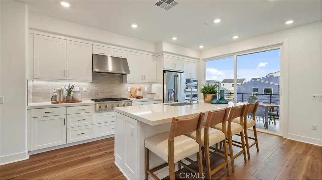 1803 Lychee Street Fullerton, CA 92833 - Photo 2 of 23 a kitchen with stainless steel appliances kitchen island granite countertop a sink and cabinets