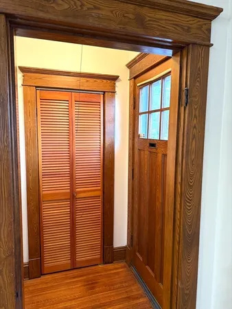 a view of a closet area with wooden floor
