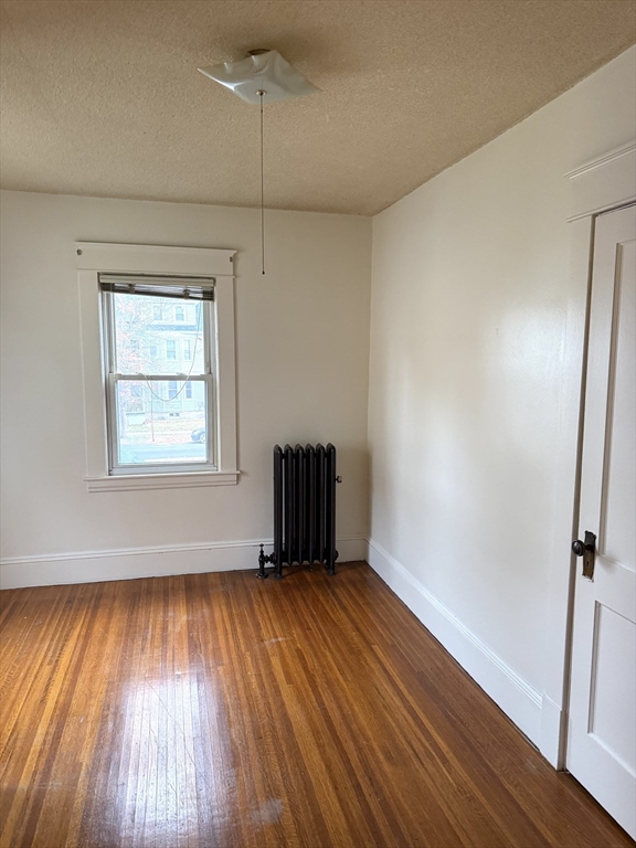 21 Westford Circle Springfield, MA 01109 - Photo 17 of 24 an empty room with wooden floor cabinet and windows