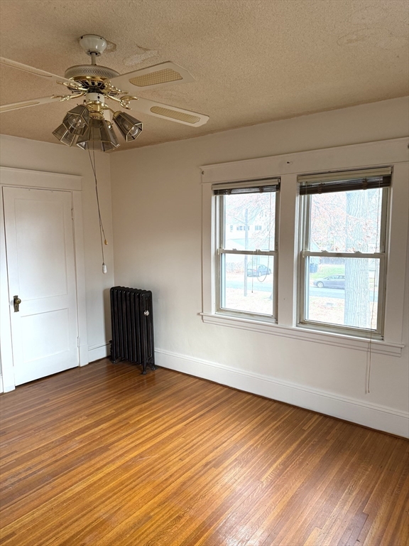 21 Westford Circle Springfield, MA 01109 - Photo 19 of 24 a view of an empty room with a window and wooden floor