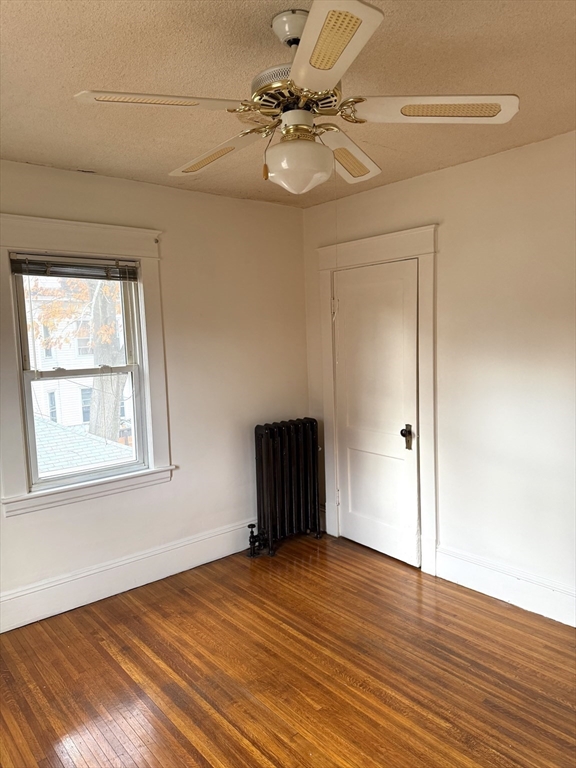 21 Westford Circle Springfield, MA 01109 - Photo 21 of 25 an empty room with wooden floor fan and windows