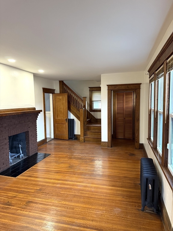 21 Westford Circle Springfield, MA 01109 - Photo 7 of 25 a view of a livingroom with wooden floor and a fireplace