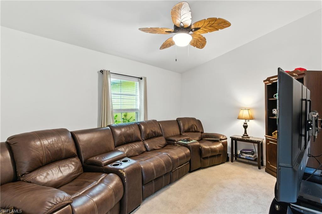 176 Venus Cay Naples, FL 34114 - Photo 11 of 50 Living area featuring light colored carpet and a ceiling fan