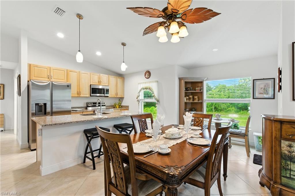 176 Venus Cay Naples, FL 34114 - Photo 13 of 50 Dining space featuring lofted ceiling, recessed lighting, light tile patterned flooring, and ceiling fan