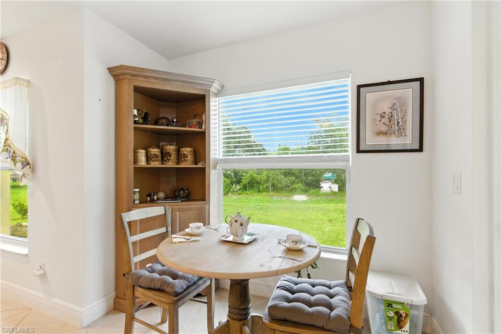 176 Venus Cay Naples, FL 34114 - Photo 16 of 50 Dining space with baseboards and light tile patterned floors