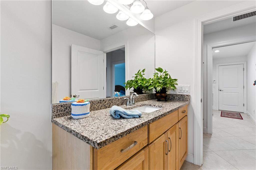 176 Venus Cay Naples, FL 34114 - Photo 24 of 50 Bathroom with vanity and light tile patterned flooring