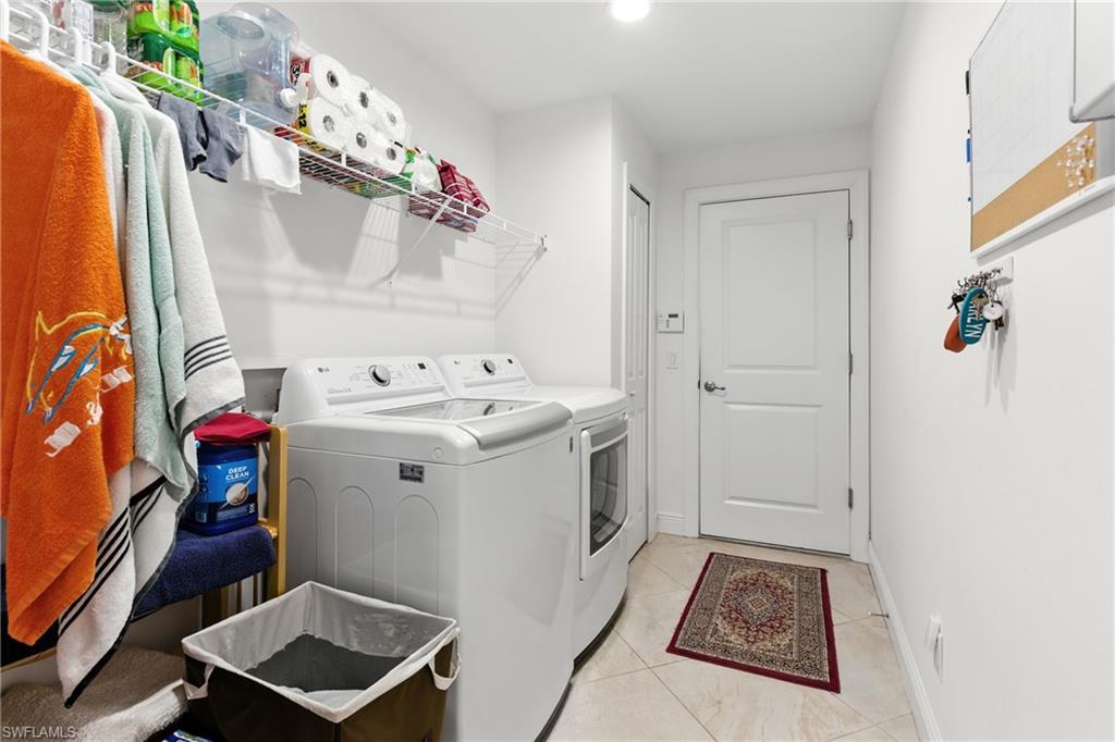 176 Venus Cay Naples, FL 34114 - Photo 25 of 50 Washroom featuring light tile patterned flooring, washing machine and clothes dryer, and recessed lighting