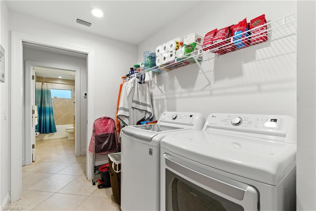 176 Venus Cay Naples, FL 34114 - Photo 26 of 50 Washroom featuring light tile patterned floors, washing machine and dryer, and recessed lighting