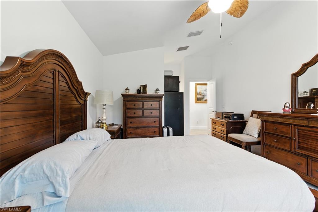 176 Venus Cay Naples, FL 34114 - Photo 34 of 50 Bedroom featuring ceiling fan and lofted ceiling