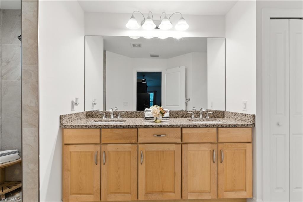 176 Venus Cay Naples, FL 34114 - Photo 35 of 50 Bathroom featuring a closet and double vanity
