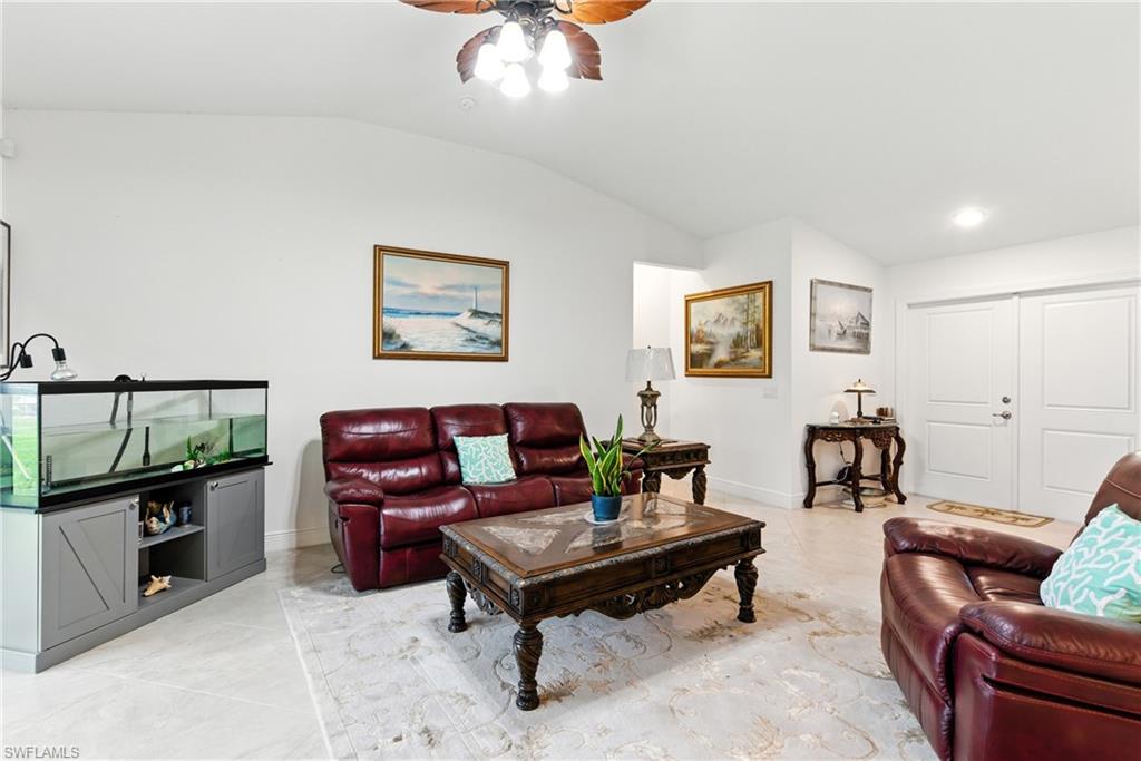 176 Venus Cay Naples, FL 34114 - Photo 8 of 50 Living area with vaulted ceiling and ceiling fan