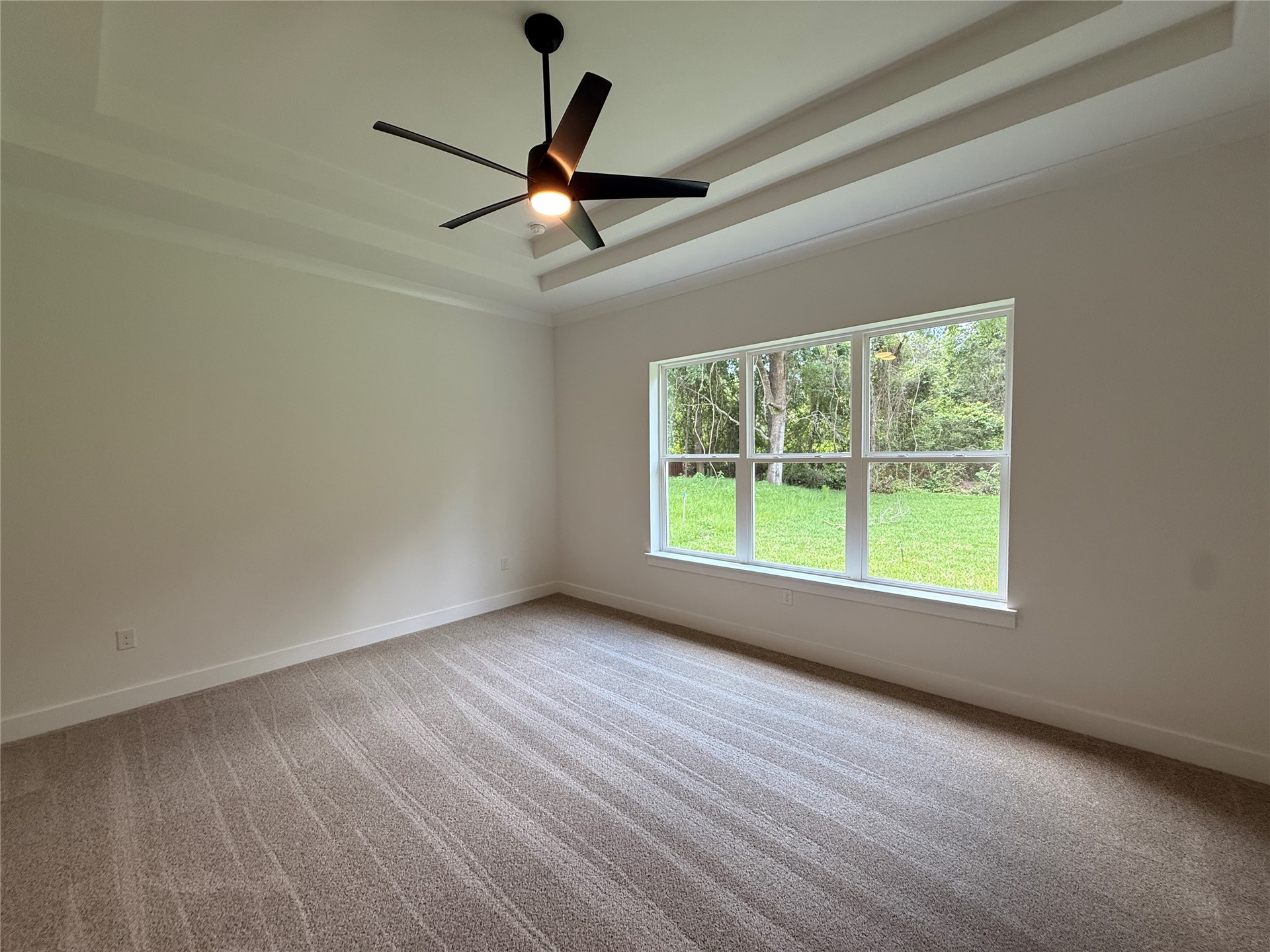 96130 Captains Pointe Road Yulee, FL 32097 - Photo 16 of 32 an empty room with wooden floor fan and windows