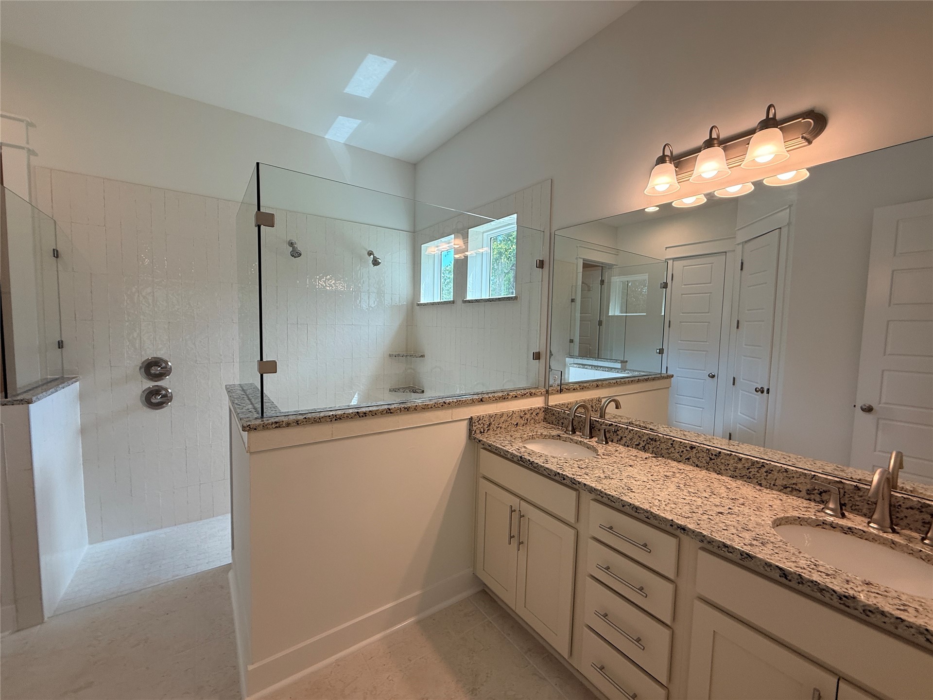 96130 Captains Pointe Road Yulee, FL 32097 - Photo 17 of 32 a bathroom with a granite countertop sink mirror and a bathtub
