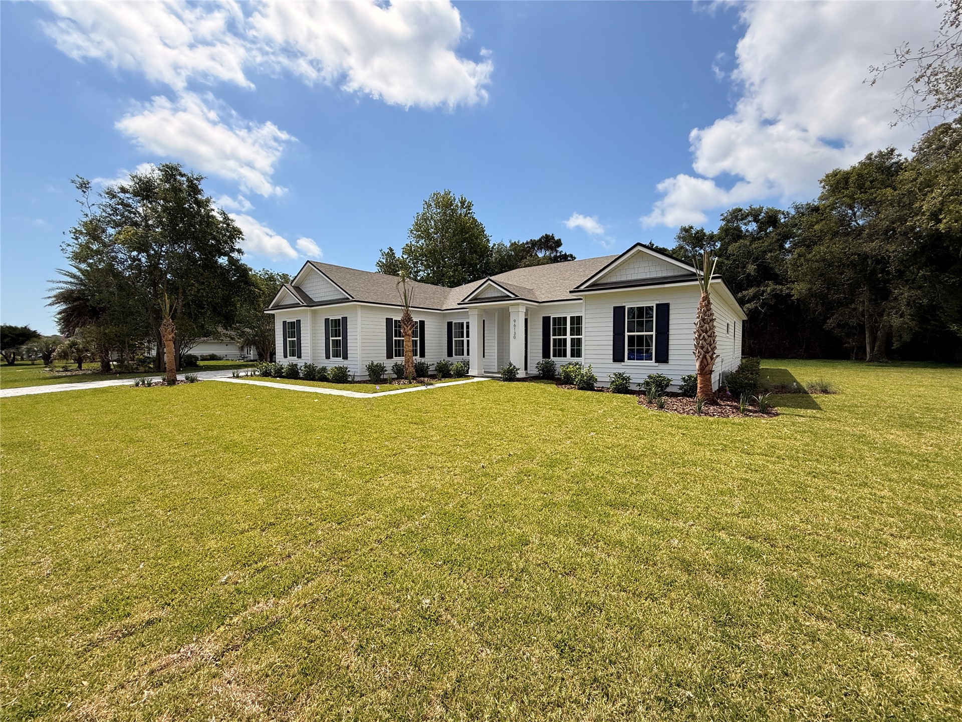 96130 Captains Pointe Road Yulee, FL 32097 - Photo 2 of 32 a front view of a house with swimming pool and porch