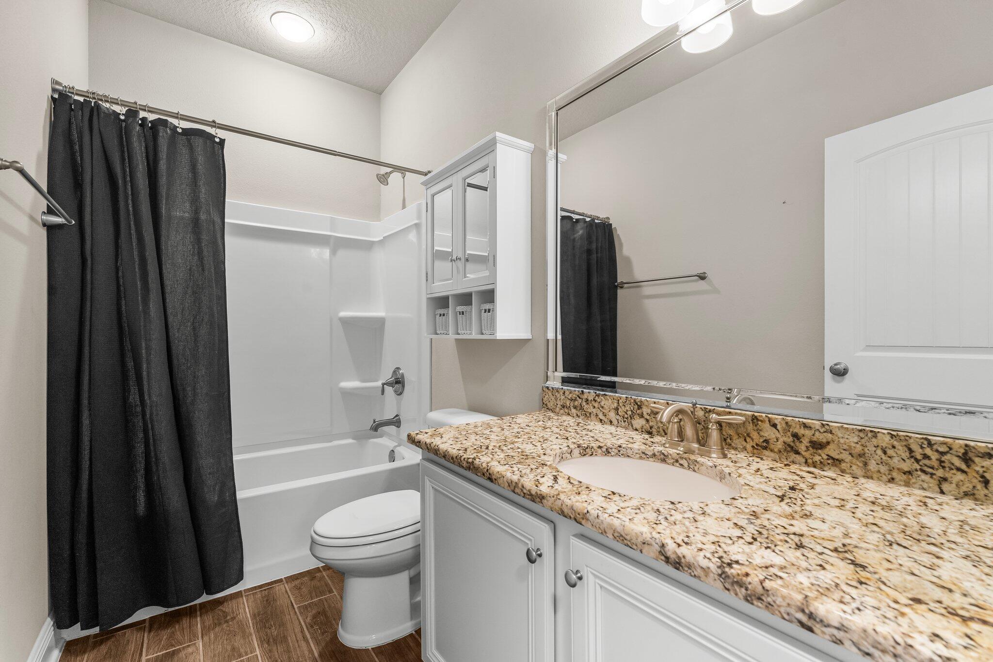 29 Buddy Lane Santa Rosa Beach, FL 32459 - Photo 15 of 47 a bathroom with a granite countertop sink toilet and shower