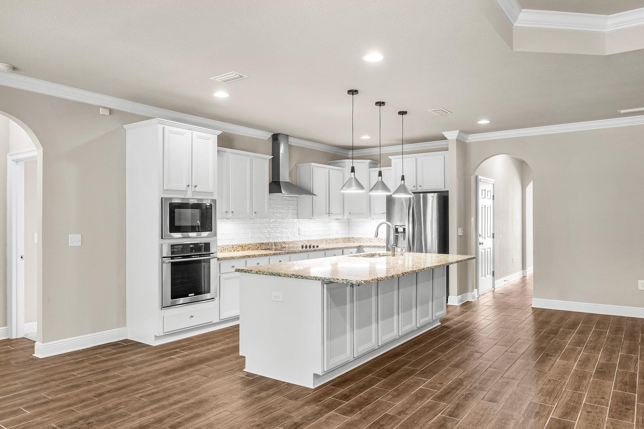 29 Buddy Lane Santa Rosa Beach, FL 32459 - Photo 21 of 47 a kitchen with stainless steel appliances a white stove top oven cabinets a refrigerator and a fireplace
