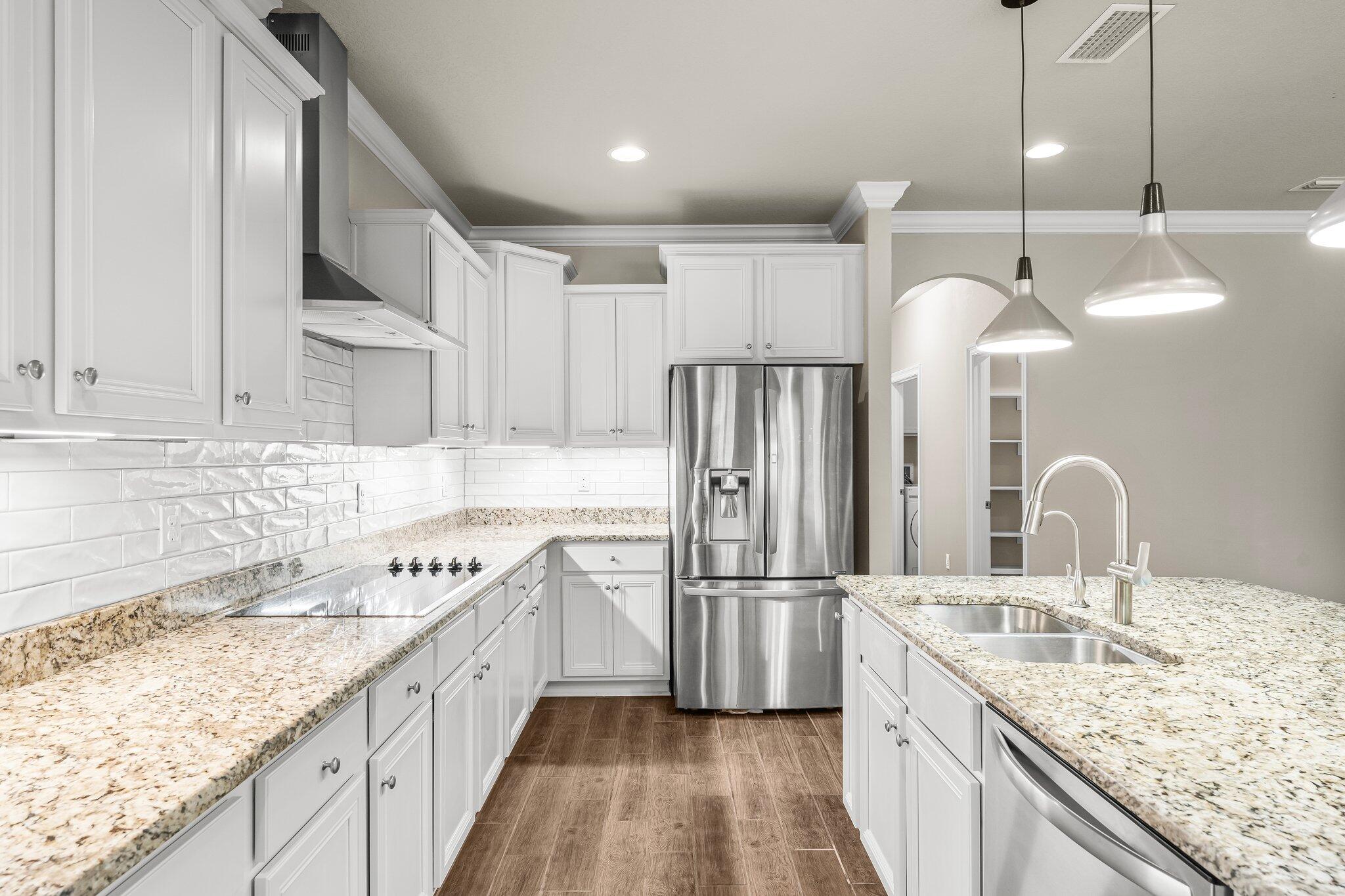 29 Buddy Lane Santa Rosa Beach, FL 32459 - Photo 22 of 47 a kitchen with stainless steel appliances granite countertop a sink refrigerator and cabinets