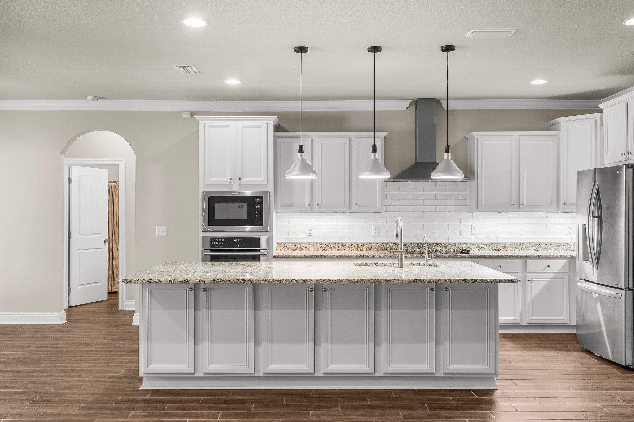 29 Buddy Lane Santa Rosa Beach, FL 32459 - Photo 23 of 47 a kitchen with stainless steel appliances granite countertop a stove a sink and a refrigerator