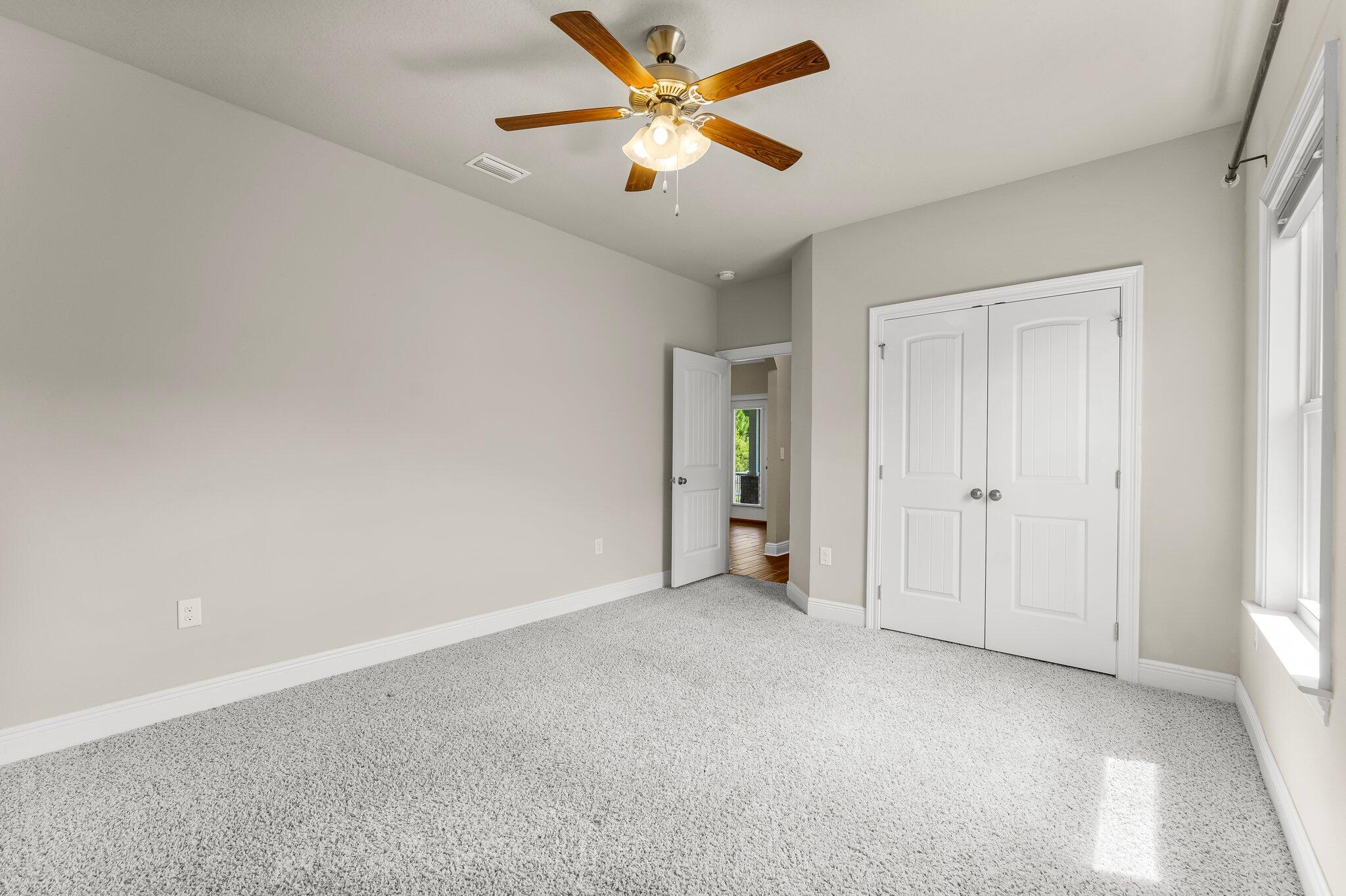 29 Buddy Lane Santa Rosa Beach, FL 32459 - Photo 27 of 47 an empty room with closet and a ceiling fan