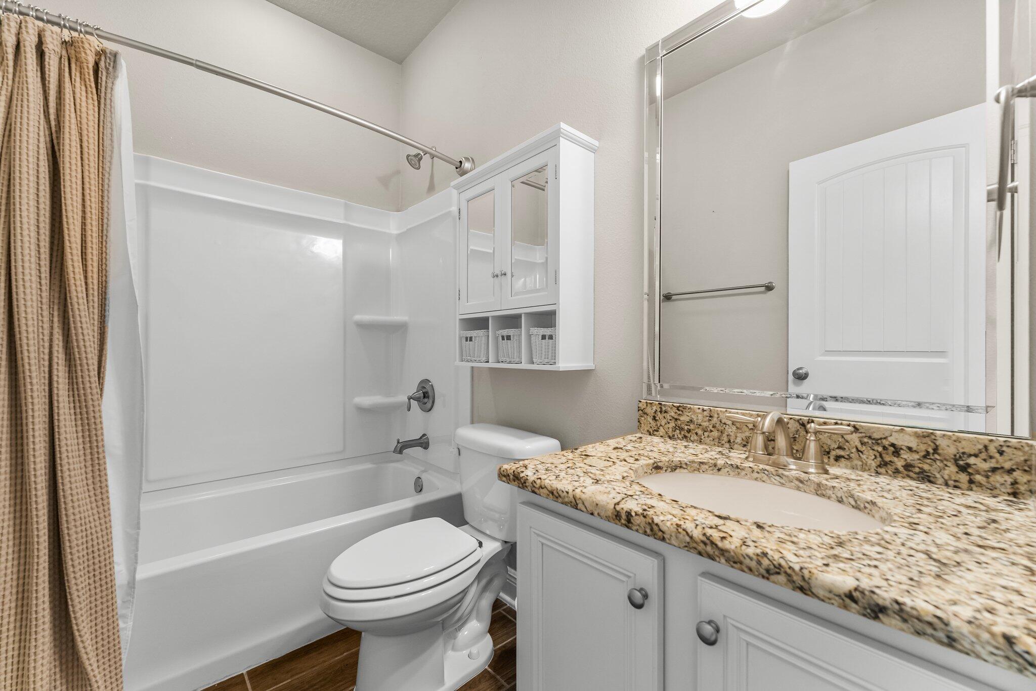 29 Buddy Lane Santa Rosa Beach, FL 32459 - Photo 28 of 47 a bathroom with a granite countertop sink toilet and shower