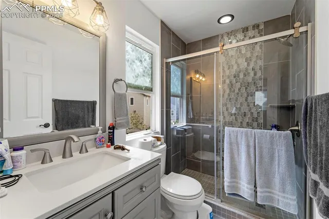 a bedroom with a bed and a mirror on dresser