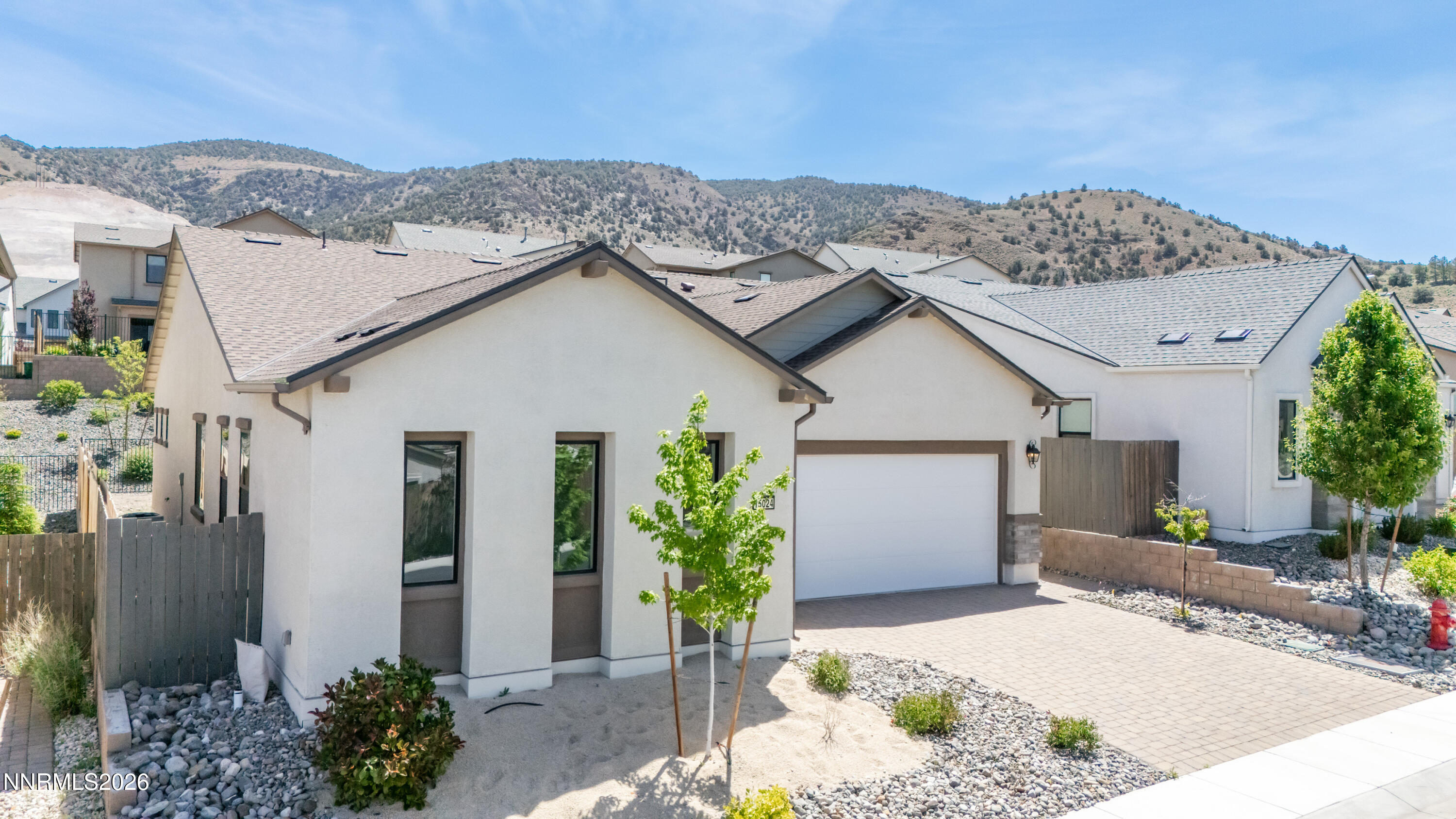 15024 Emerald Sunset Lane Reno, NV 89521 - Photo 2 of 73 a view of a house with a yard and potted plants