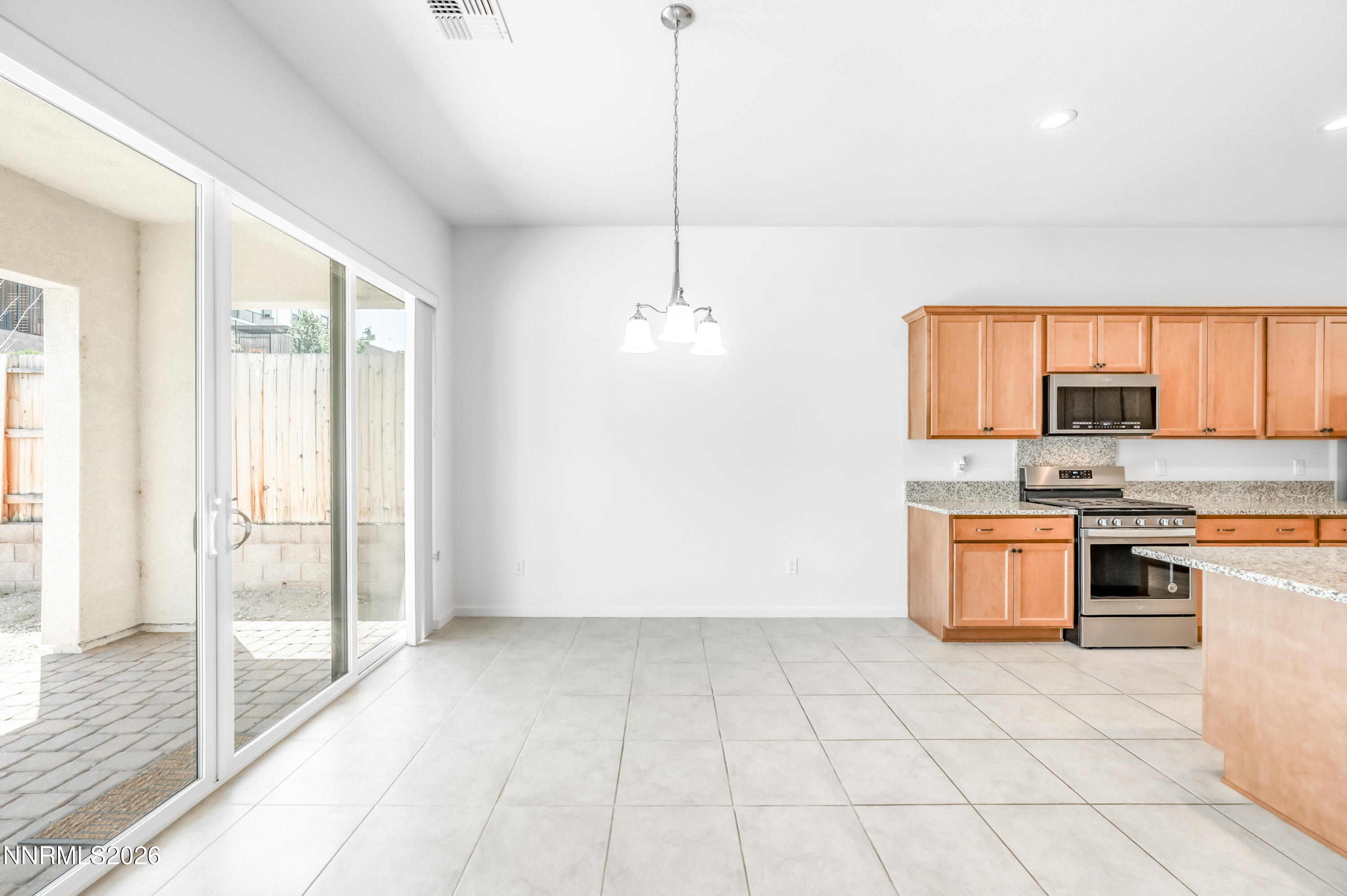 15024 Emerald Sunset Lane Reno, NV 89521 - Photo 22 of 73 a kitchen with stainless steel appliances granite countertop a stove a sink and a refrigerator