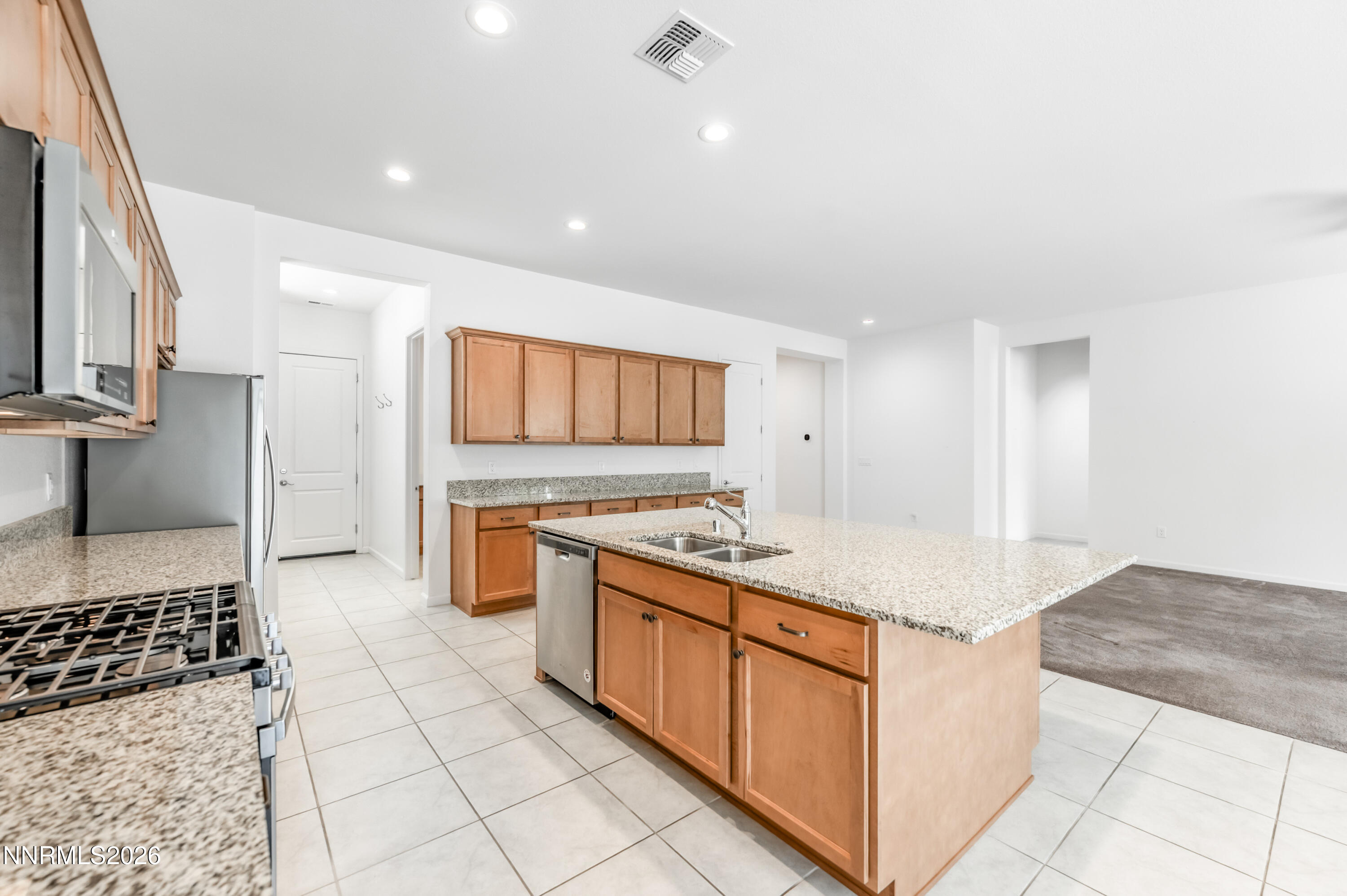 15024 Emerald Sunset Lane Reno, NV 89521 - Photo 24 of 73 a kitchen with stainless steel appliances granite countertop a sink and a stove