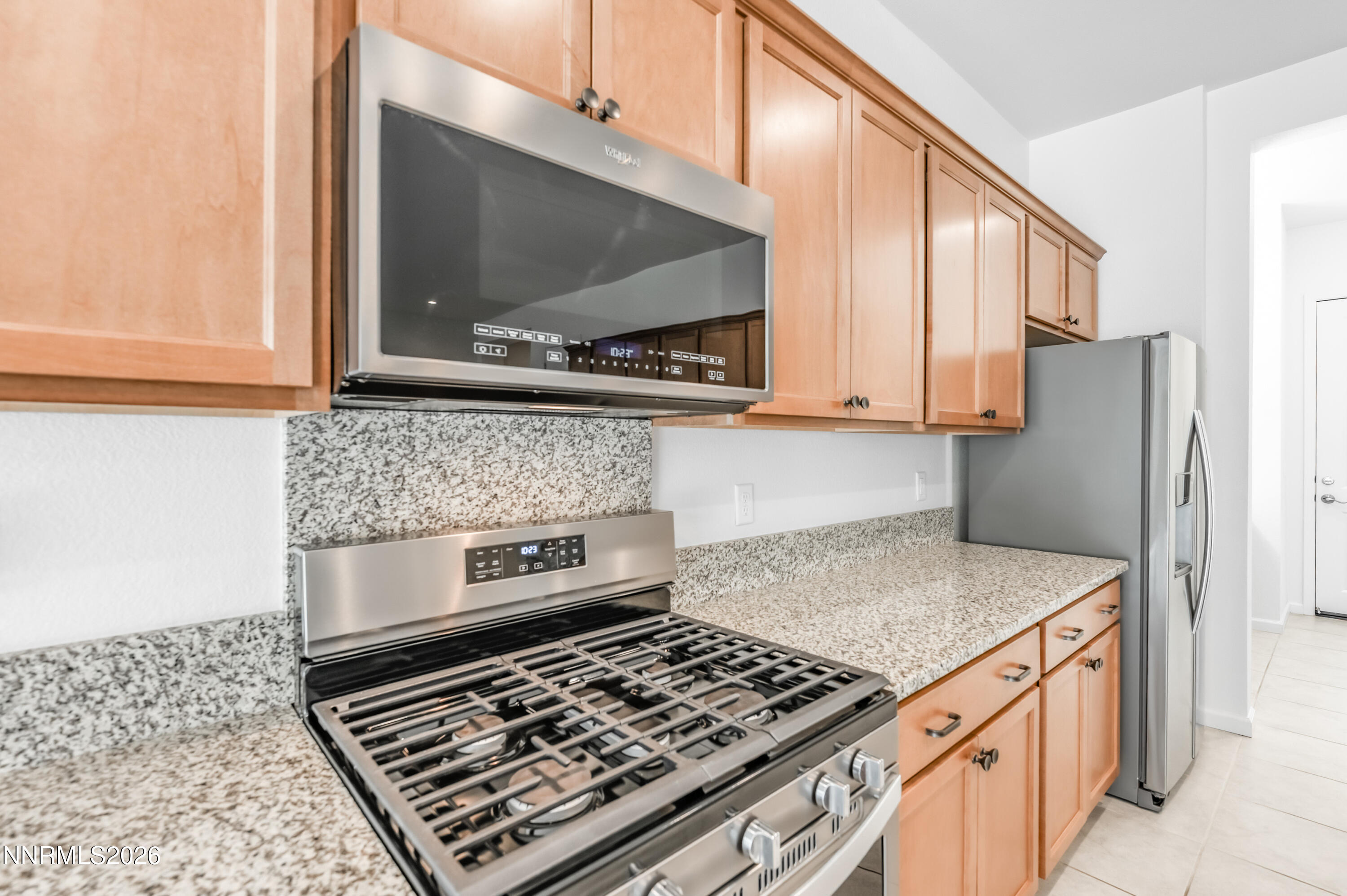 15024 Emerald Sunset Lane Reno, NV 89521 - Photo 29 of 73 a kitchen with stainless steel appliances granite countertop a stove and a microwave