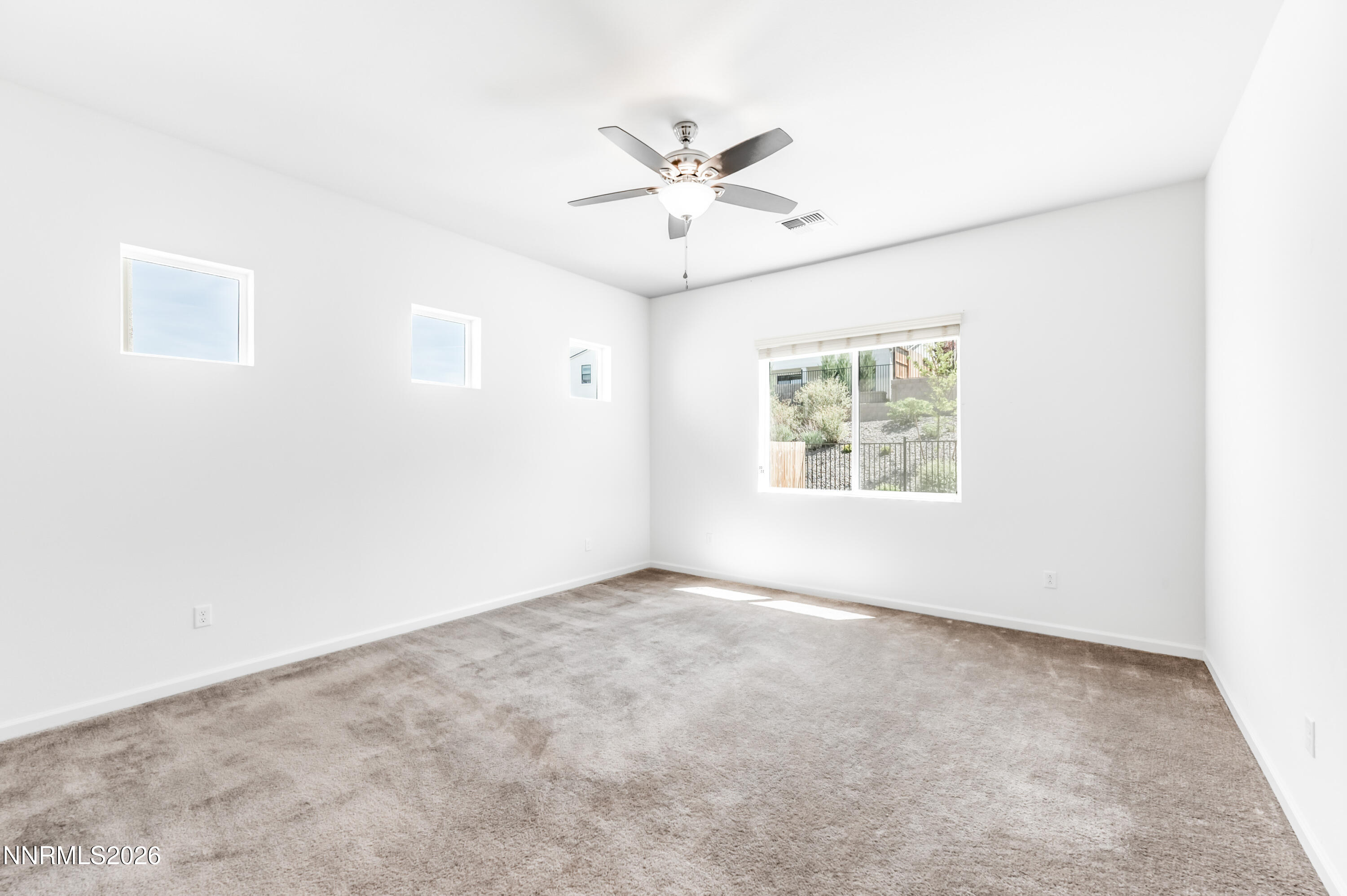 15024 Emerald Sunset Lane Reno, NV 89521 - Photo 31 of 73 an empty room with window and ceiling fan