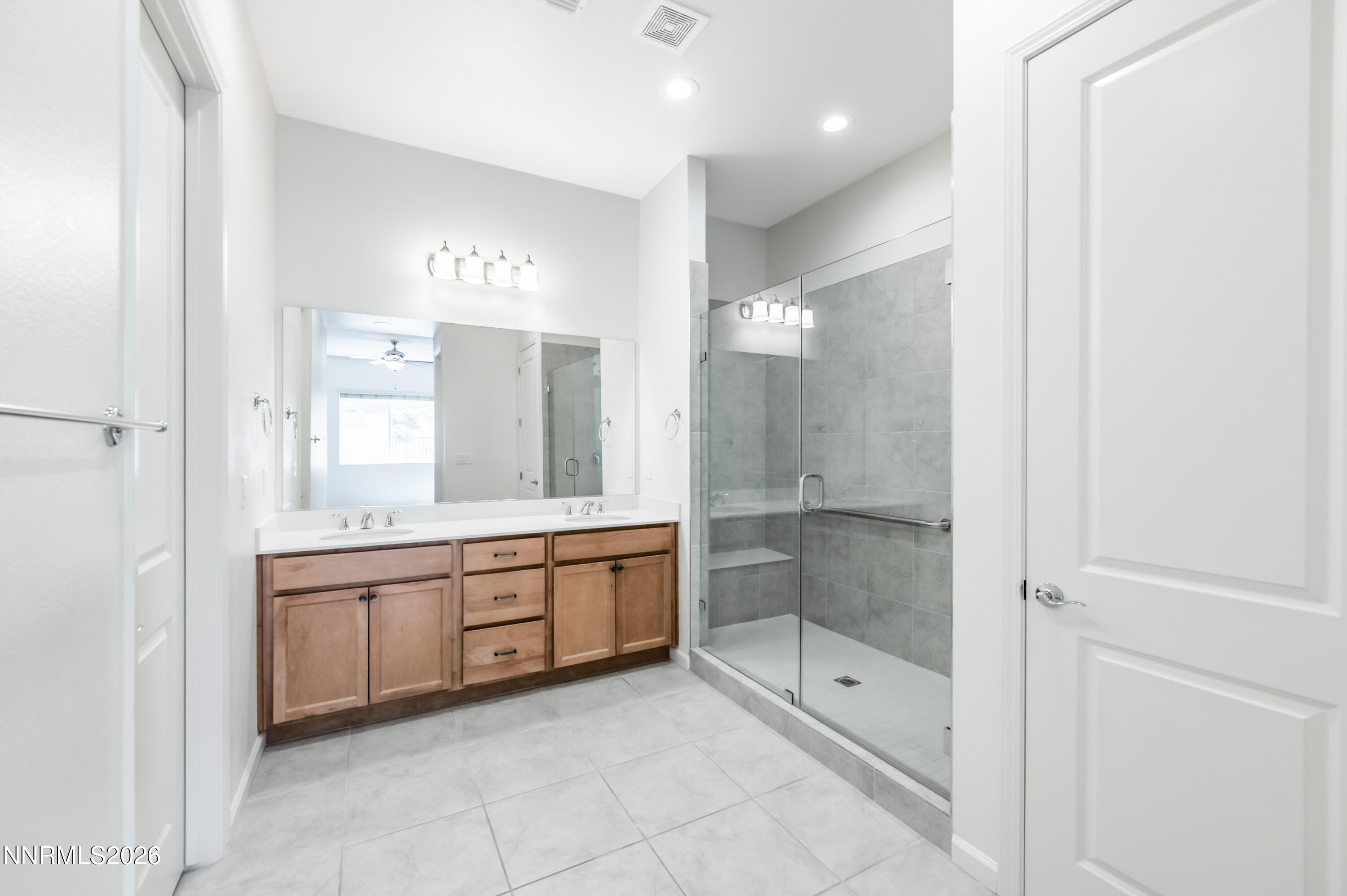 15024 Emerald Sunset Lane Reno, NV 89521 - Photo 35 of 73 a bathroom with a granite countertop sink mirror and bathtub