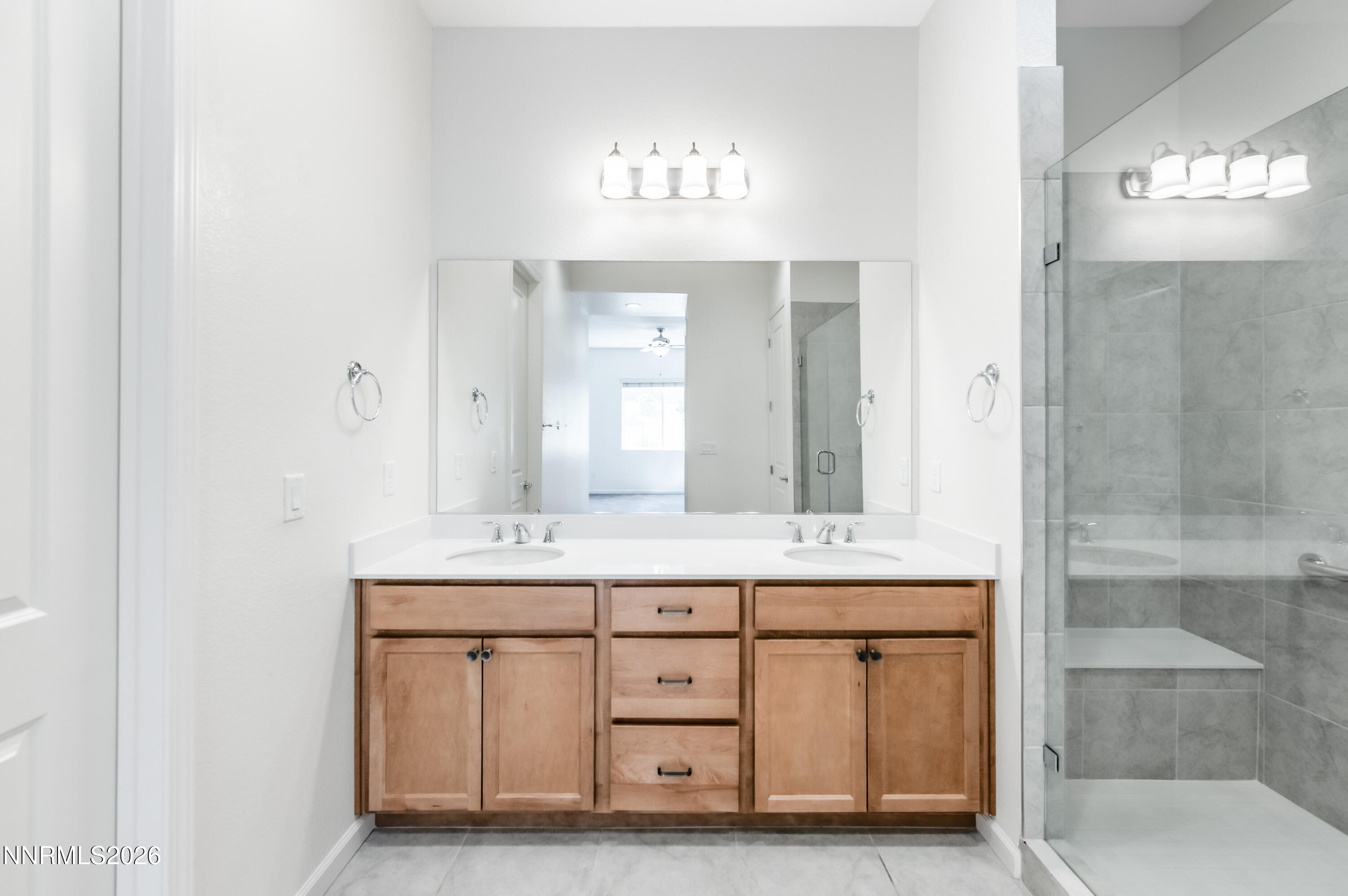 15024 Emerald Sunset Lane Reno, NV 89521 - Photo 36 of 73 a bathroom with a sink a mirror and a shower