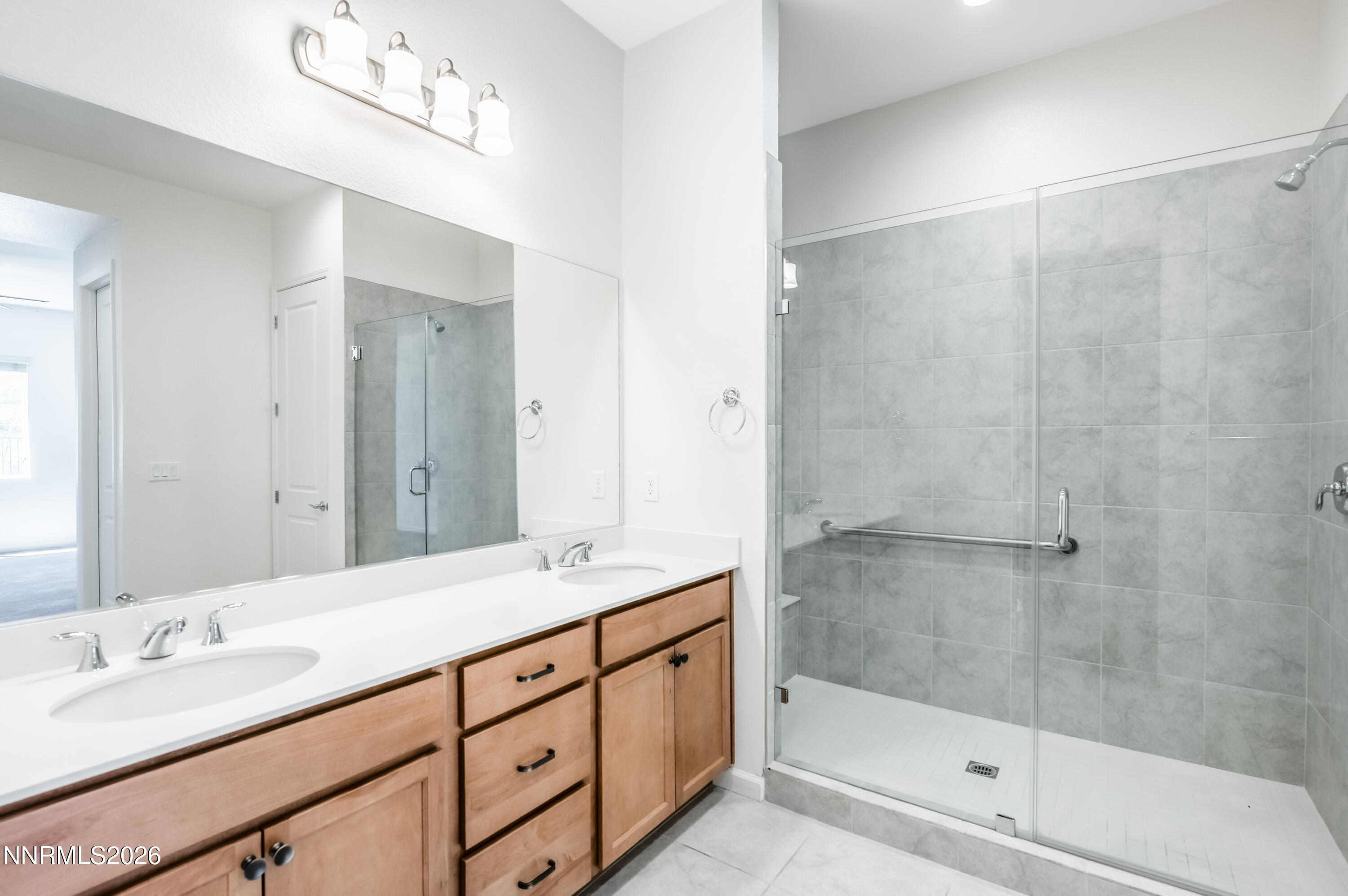 15024 Emerald Sunset Lane Reno, NV 89521 - Photo 37 of 73 a bathroom with a double vanity sink mirror and shower