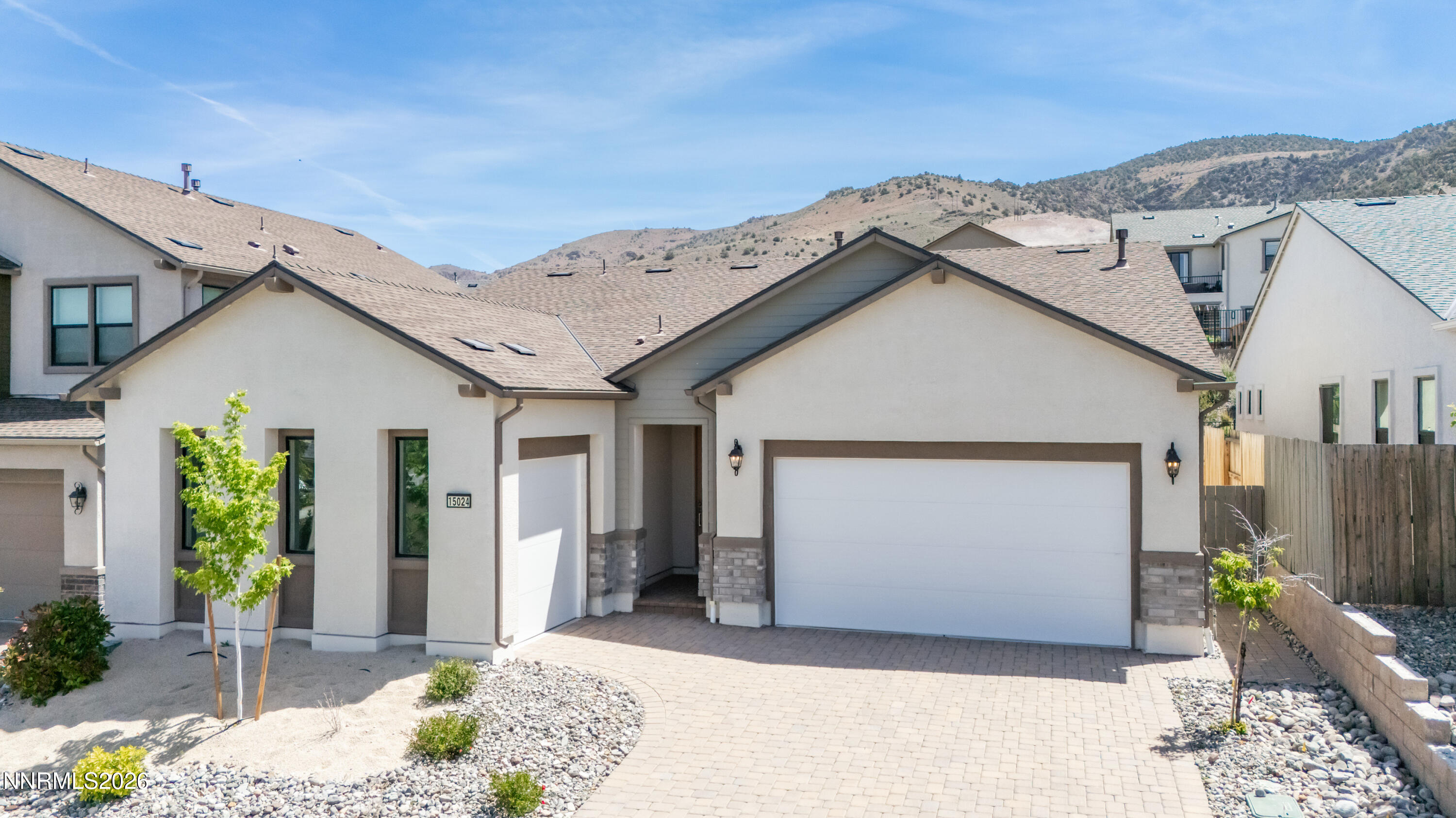 15024 Emerald Sunset Lane Reno, NV 89521 - Photo 4 of 73 a view of a white house next to a yard
