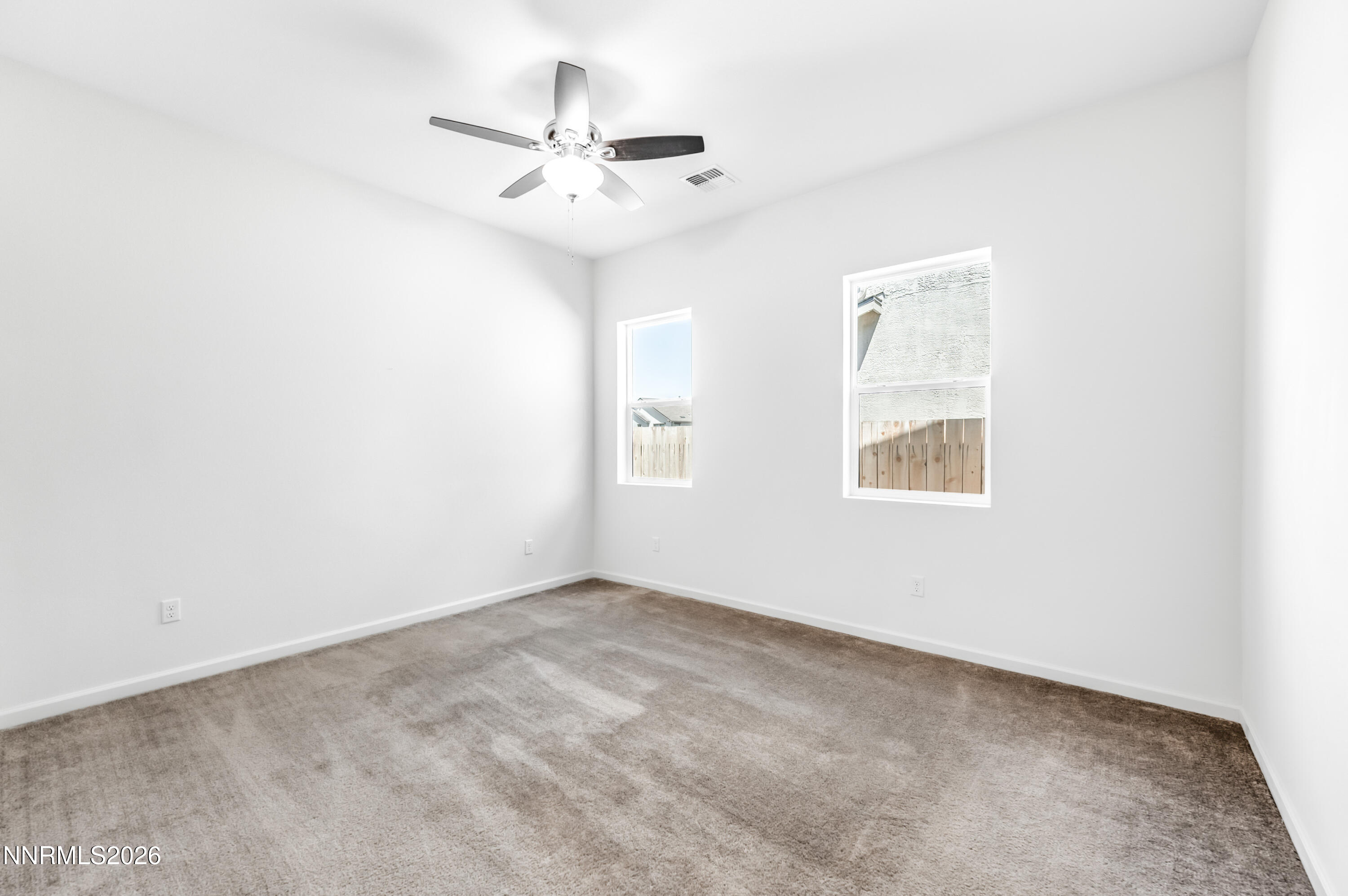 15024 Emerald Sunset Lane Reno, NV 89521 - Photo 41 of 73 an empty room with windows and fan
