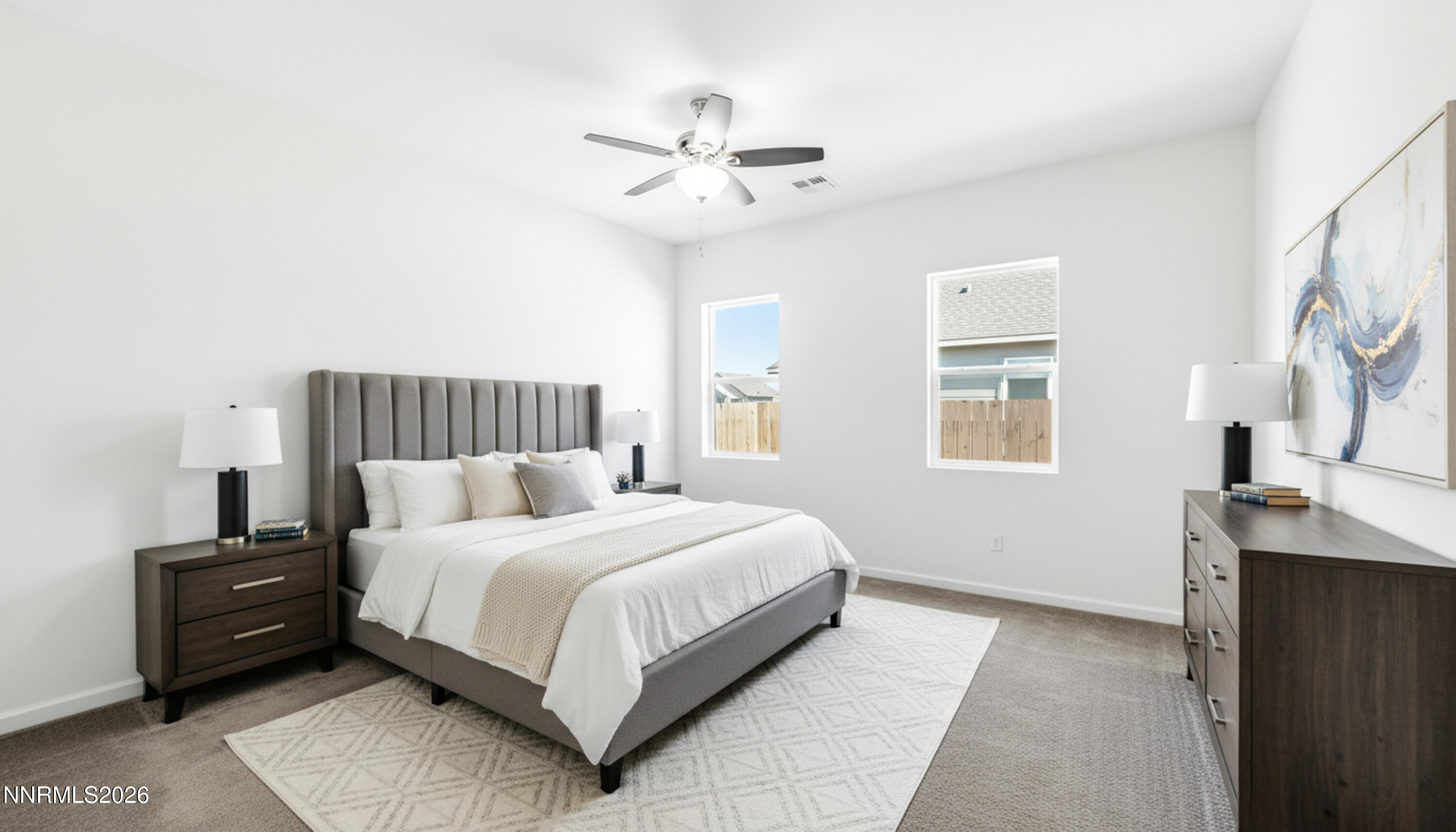 15024 Emerald Sunset Lane Reno, NV 89521 - Photo 42 of 73 a bedroom with a large bed and a chandelier