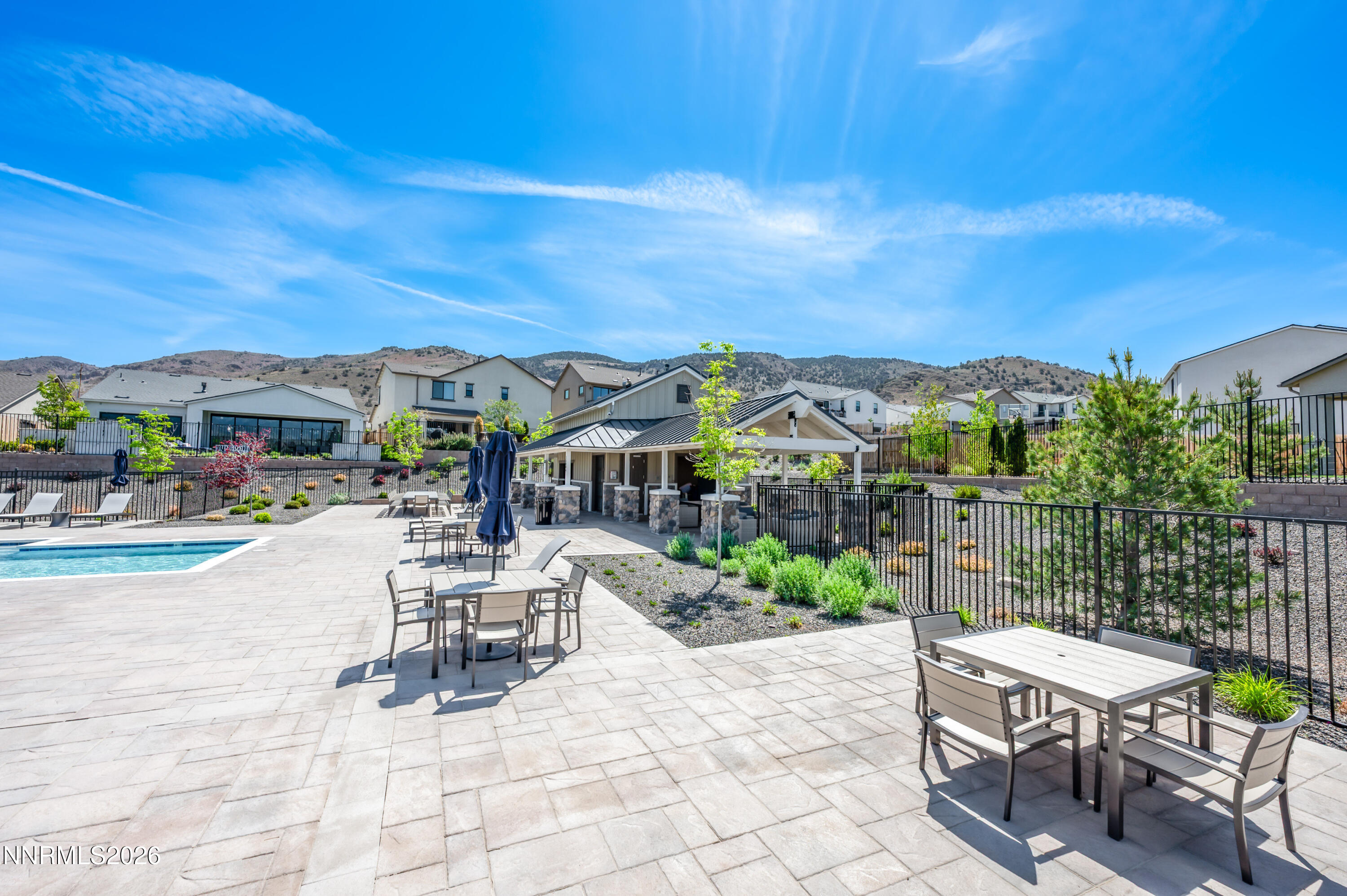 15024 Emerald Sunset Lane Reno, NV 89521 - Photo 69 of 73 a view of a patio with a table and chairs under an umbrella