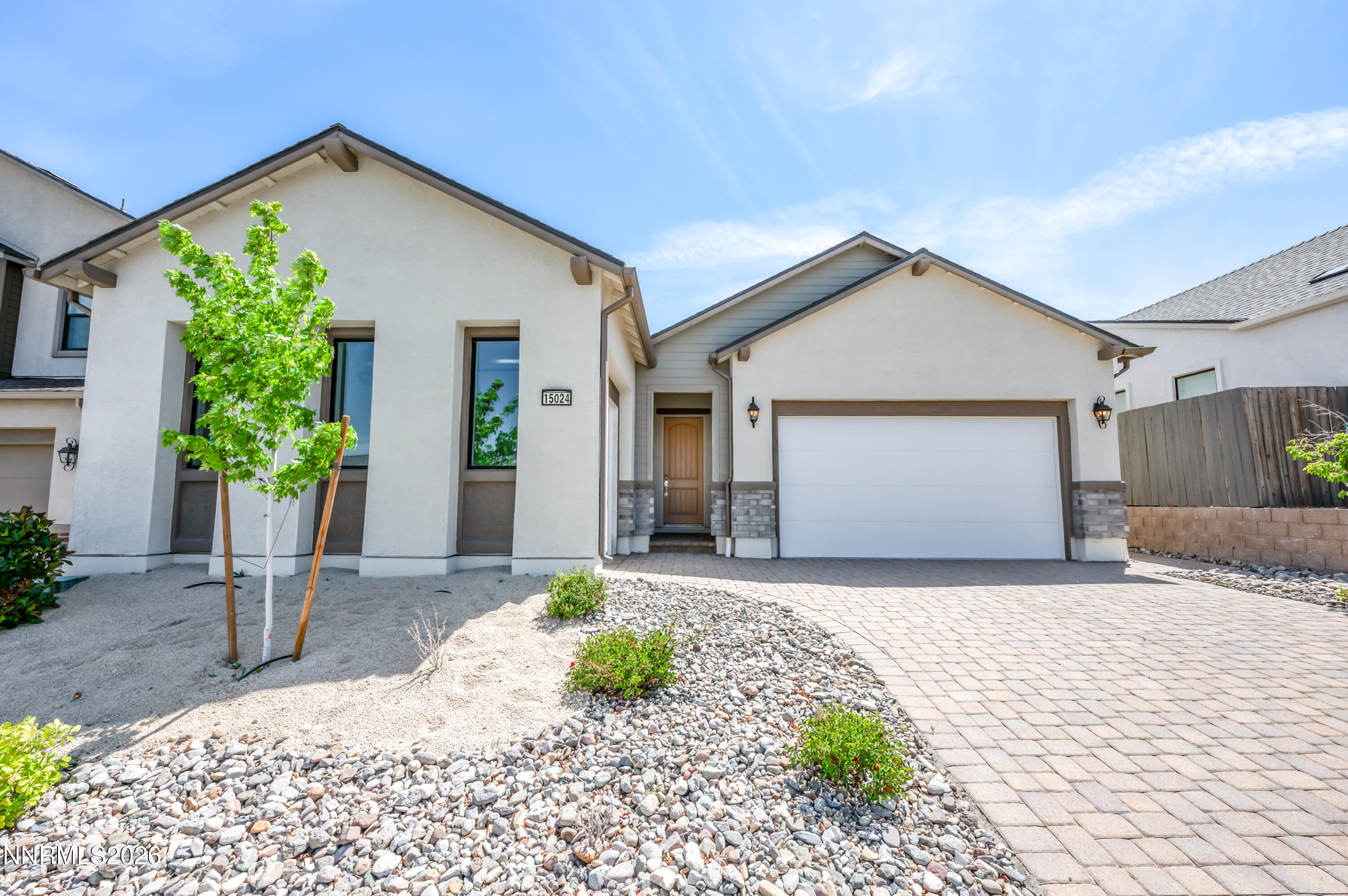 15024 Emerald Sunset Lane Reno, NV 89521 - Photo 7 of 73 a front view of a house with a yard and garage