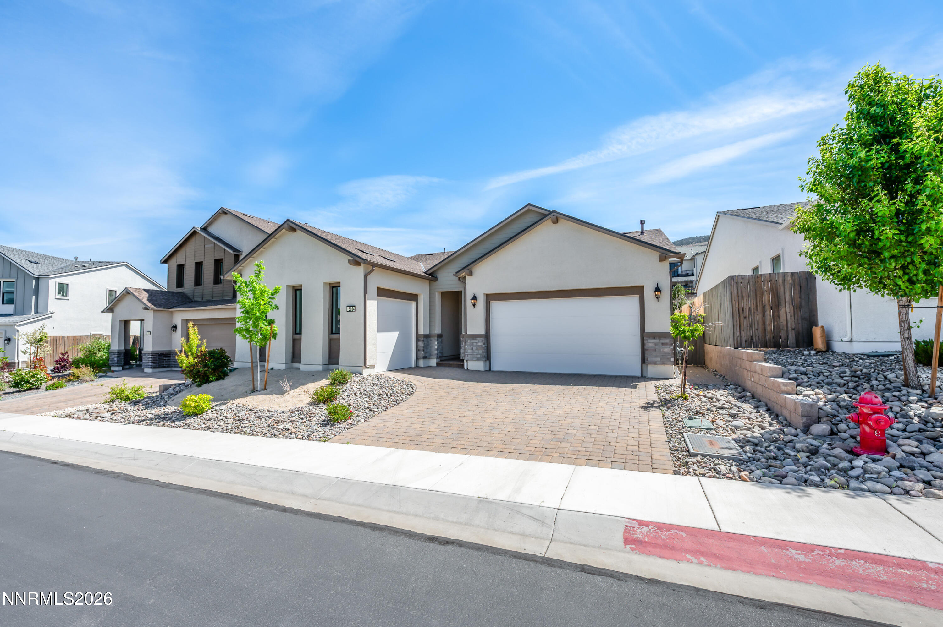 15024 Emerald Sunset Lane Reno, NV 89521 - Photo 8 of 73 a front view of a house with a yard and garage