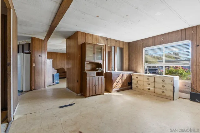 a view of a bedroom with furniture and a window