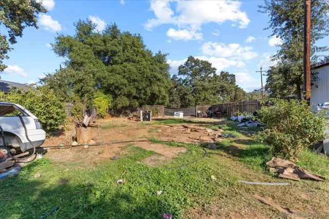 a view of a yard with yellow house