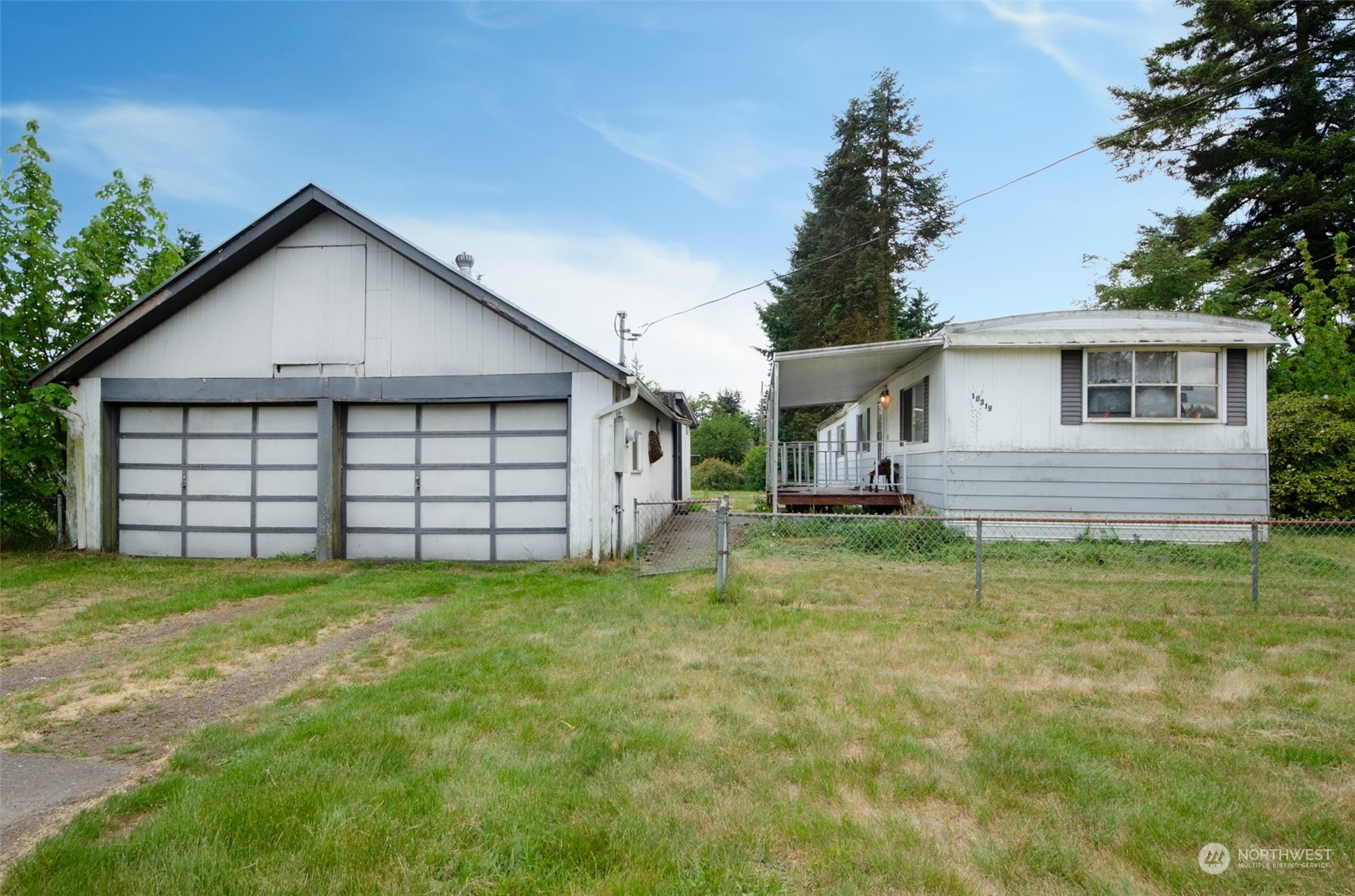 a view of a house with a yard and garage