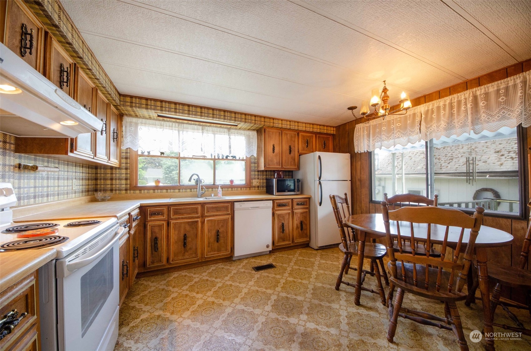 10319 184th Avenue Southwest Rochester, WA 98579 - Photo 6 of 14 a kitchen with a table chairs sink and cabinets