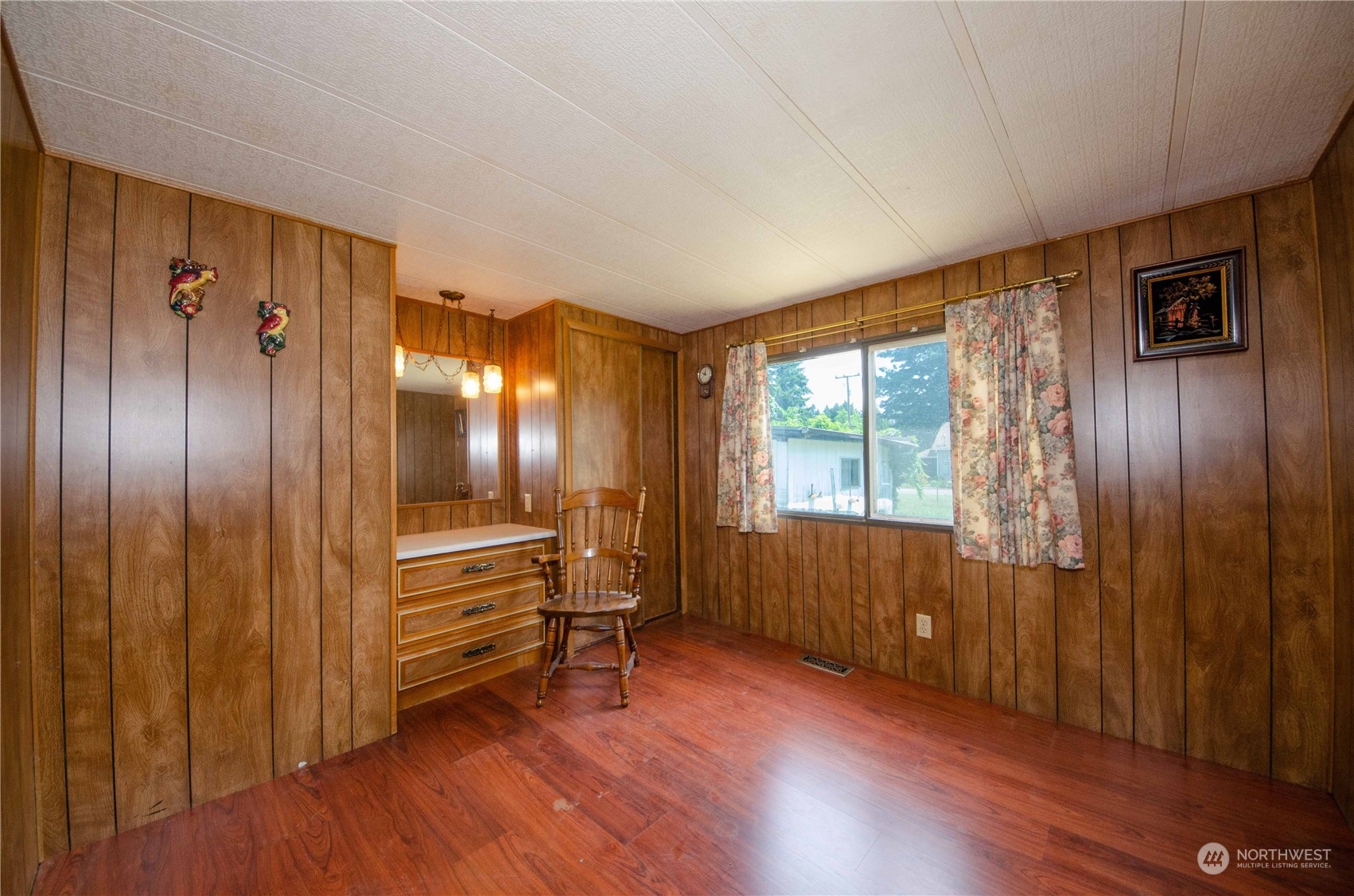 10319 184th Avenue Southwest Rochester, WA 98579 - Photo 10 of 14 a view of an empty room with wooden floor and a window