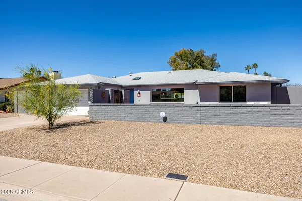 a front view of a house with a yard and a garage