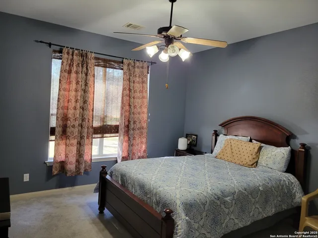 a bedroom with a bed and a desk