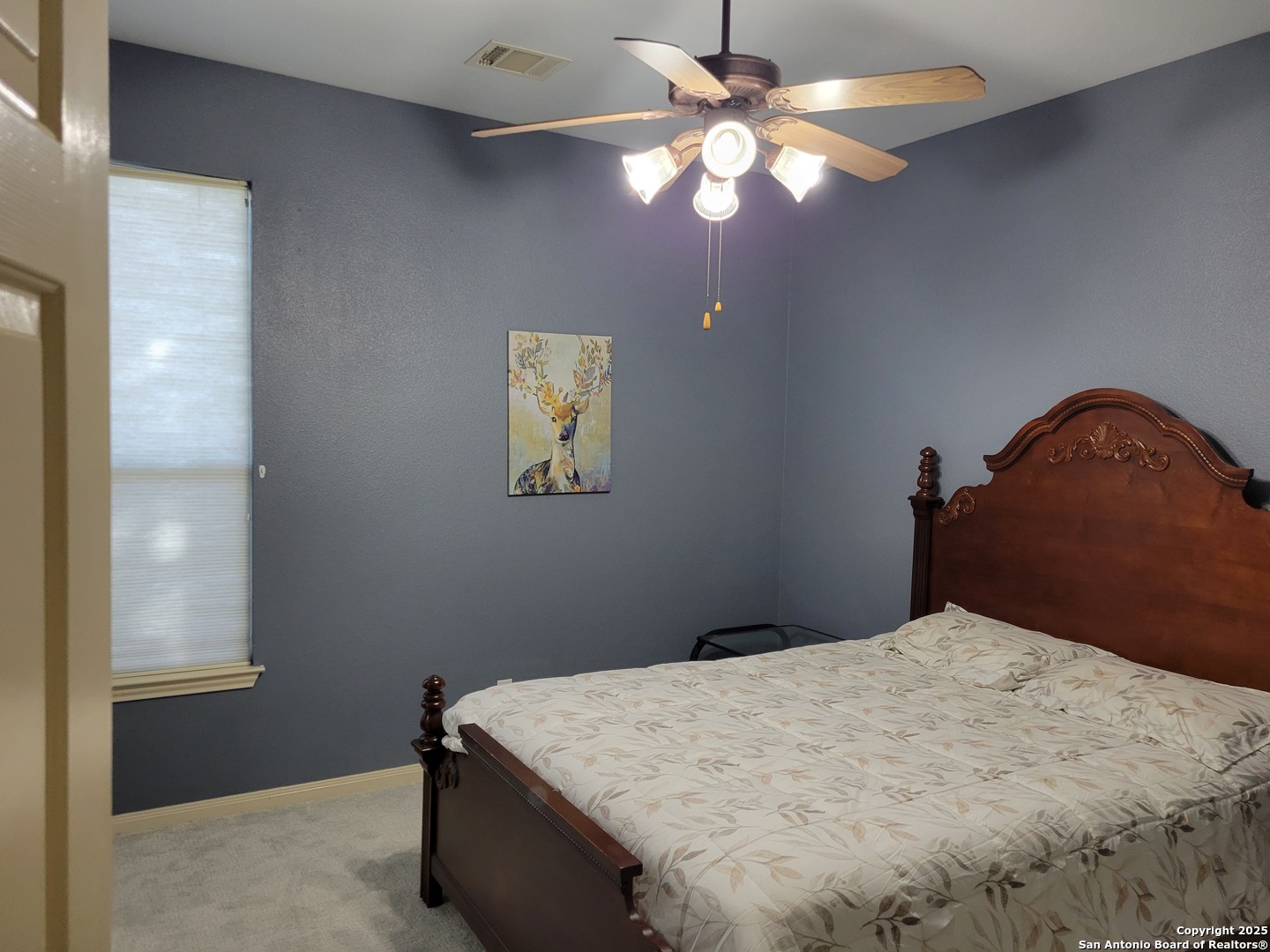 1722 Palmer San Antonio, TX 78260 - Photo 10 of 35 a bedroom with a bed and a chandelier